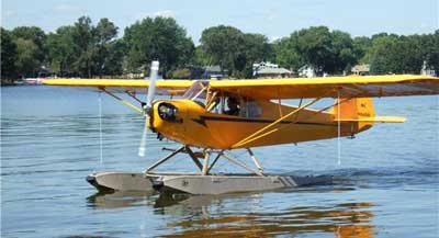 Piper J-3 on floats taxiing
