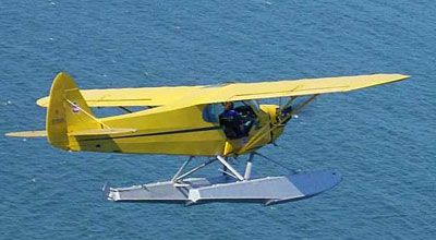 Piper Cub In flight over water
